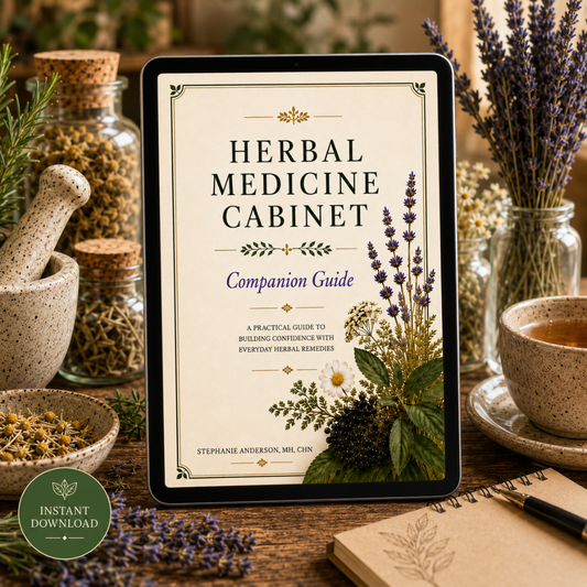 A tablet displaying the cover of a digital guide titled 'Herbal Medicine Cabinet: Companion Guide' stands on a wooden table surrounded by jars of dried herbs, a cup of tea, and lavender stems. A green 'Instant Download' badge appears in the lower-left corner.